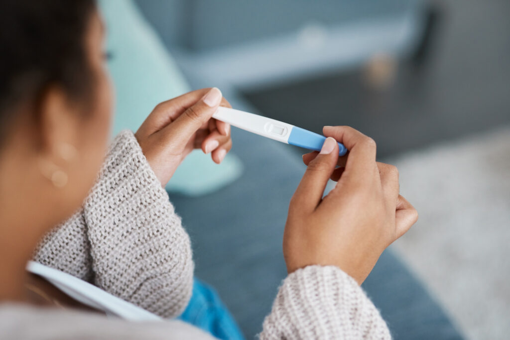 Woman with pregnancy symptoms take free pregnancy test at Alternative Care Center.
